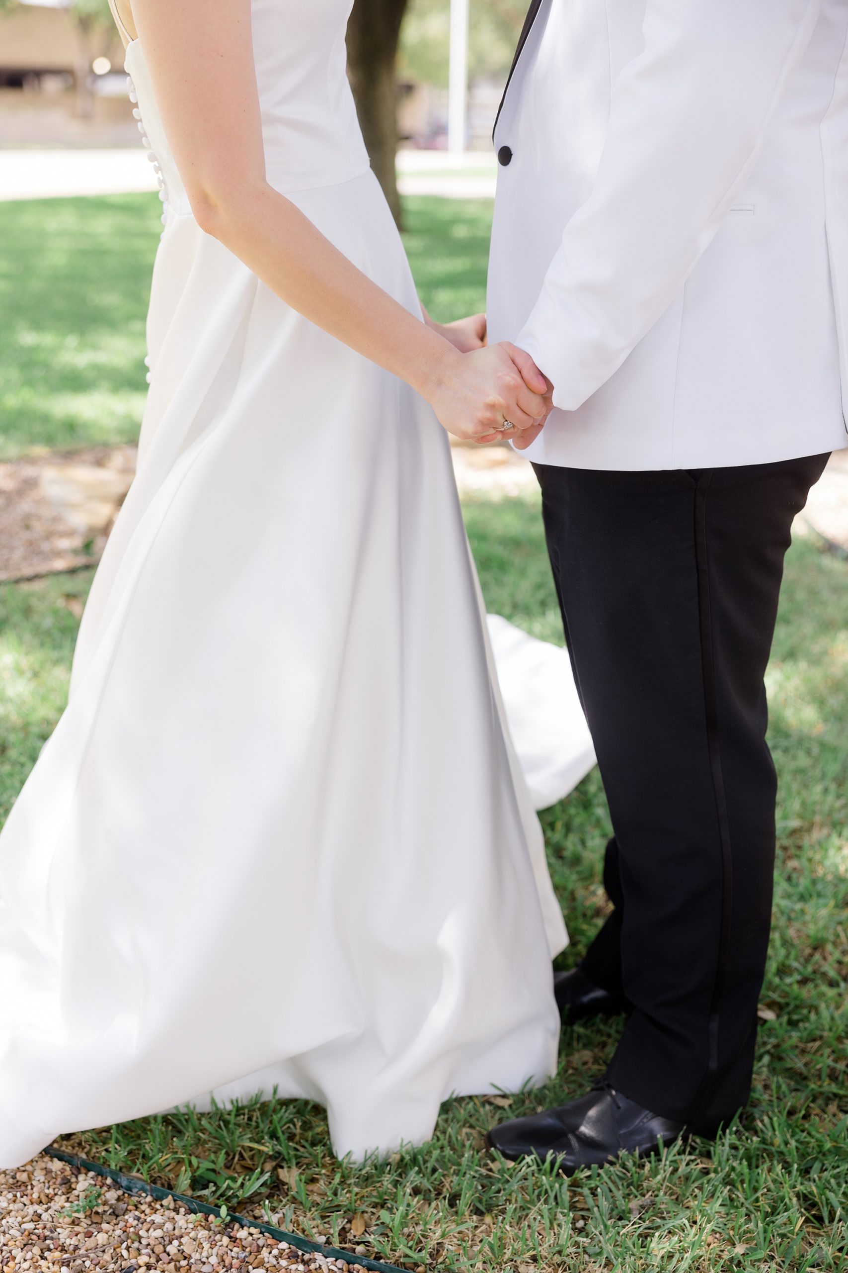 bride and groom hold hands on lawn in Fort Worth TX
