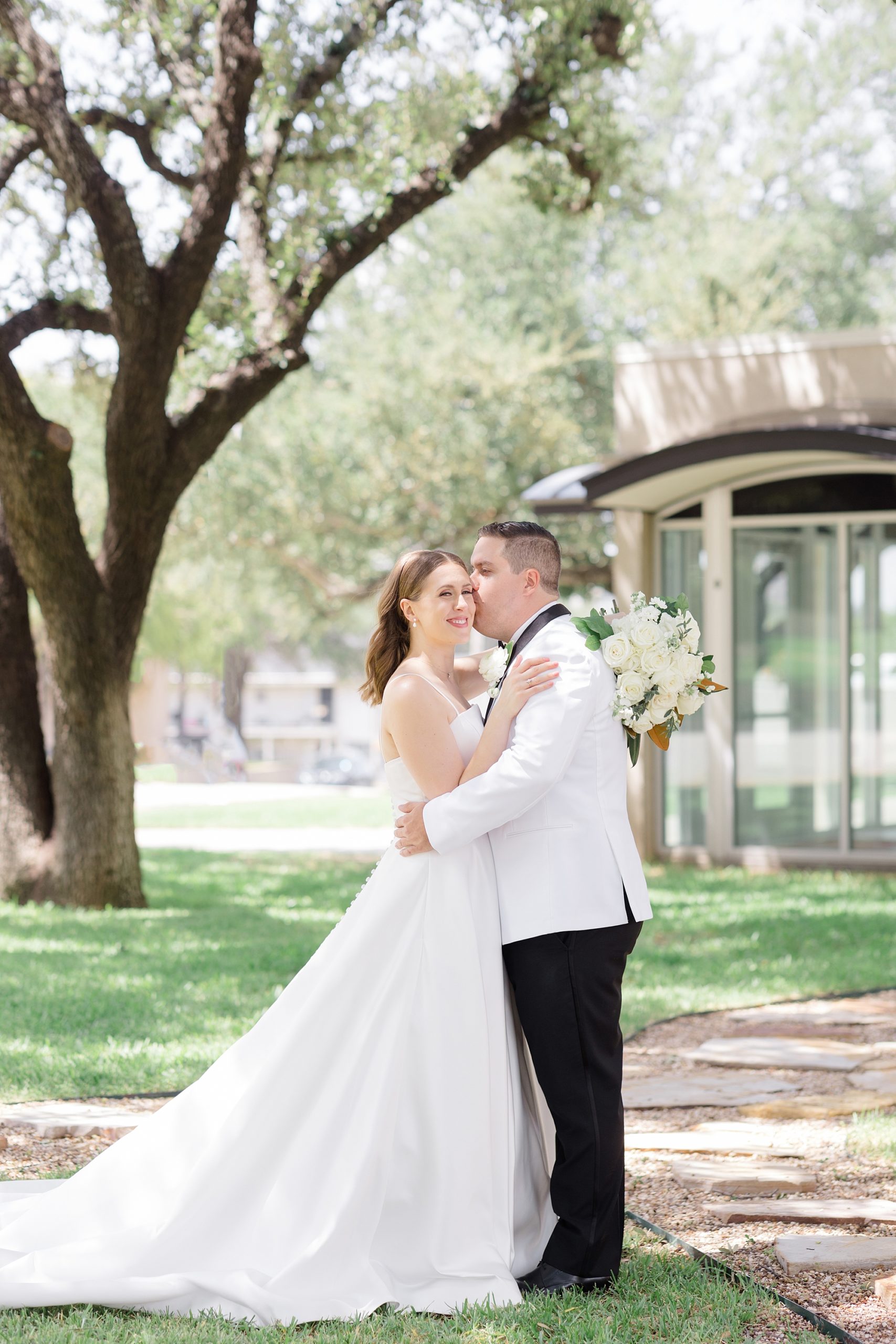 groom kisses bride's forehead during portraits in Fort Worth TX