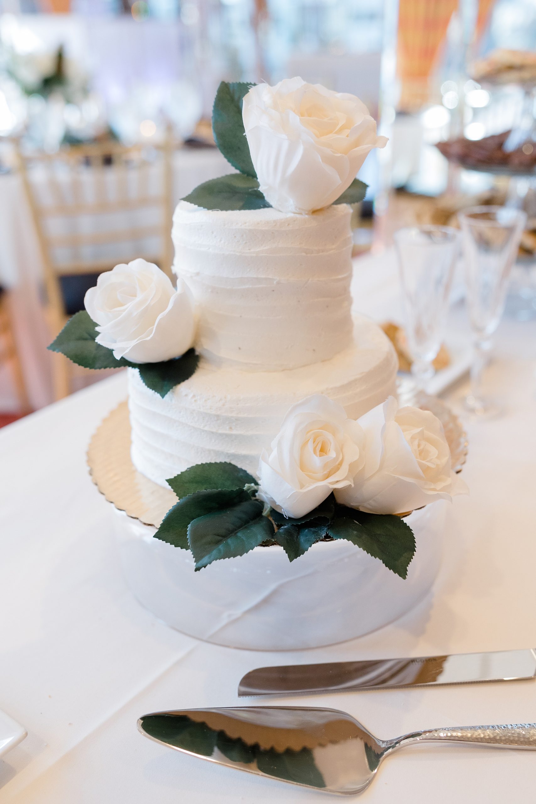 tiered wedding cake with ivory rose accents 