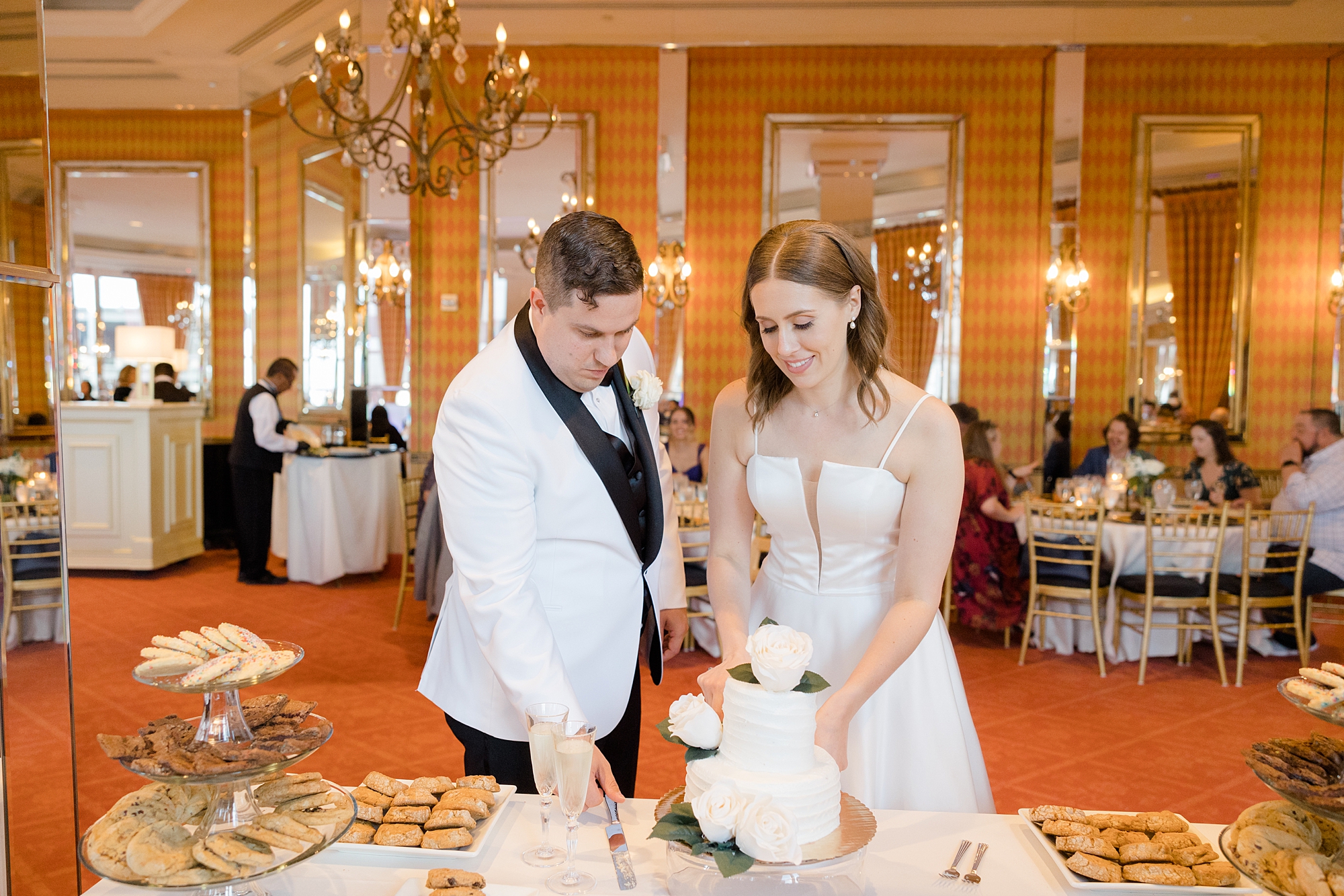 bride and groom cut wedding cake during Fort Worth City Club wedding reception 