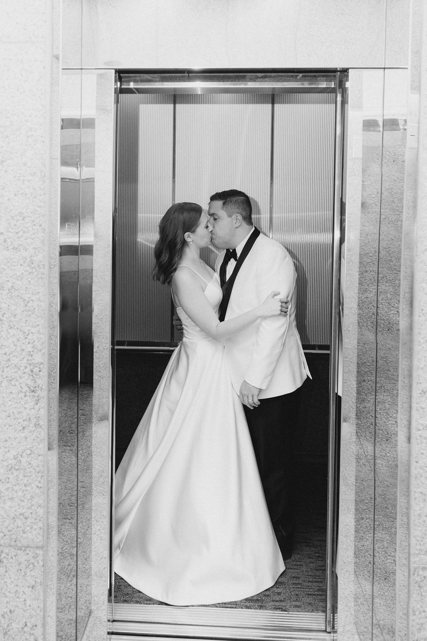 newlyweds kiss in elevator at the Fort Worth City Club