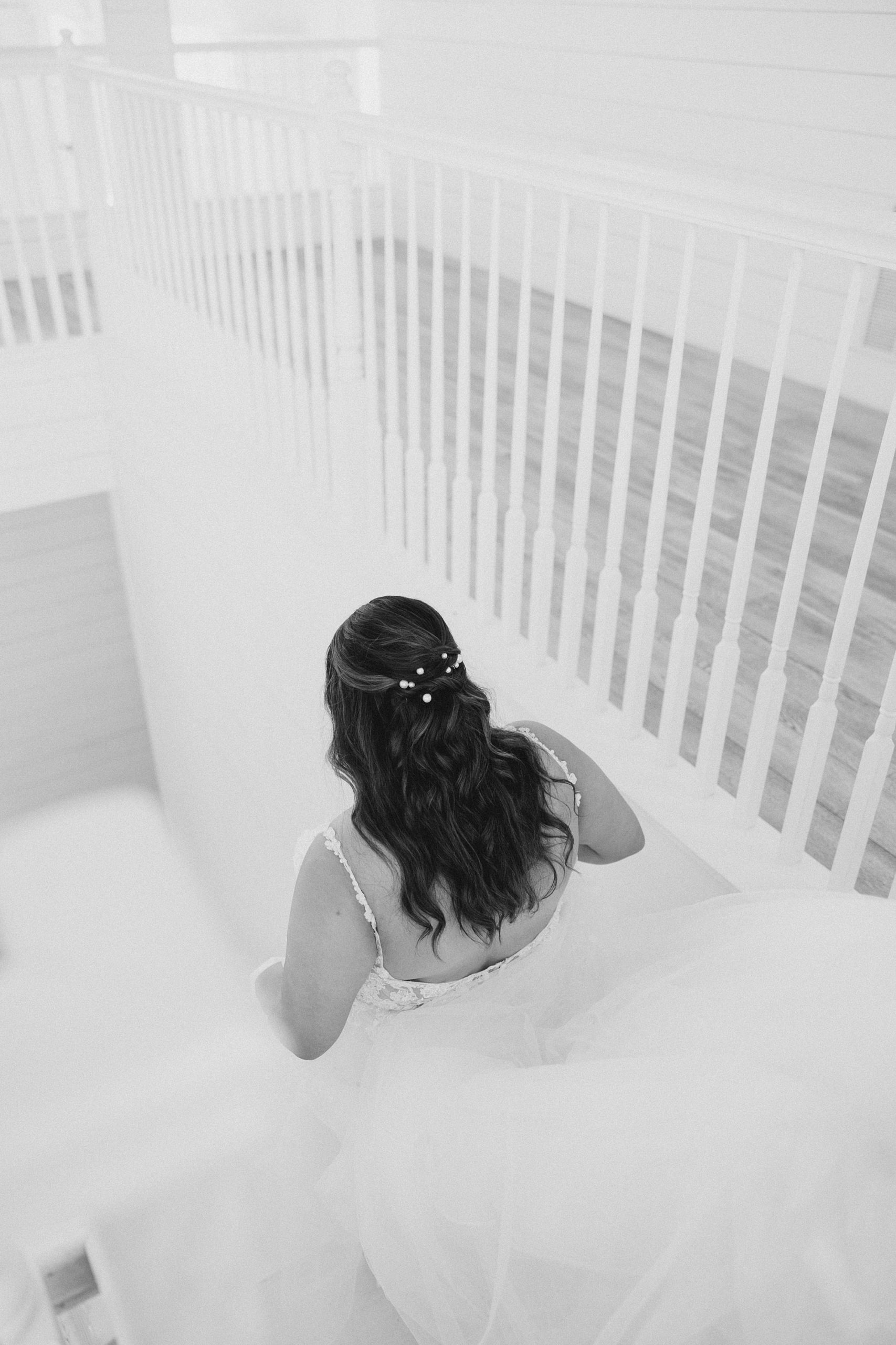bride walks down steps inside The Nest at Ruth Farms