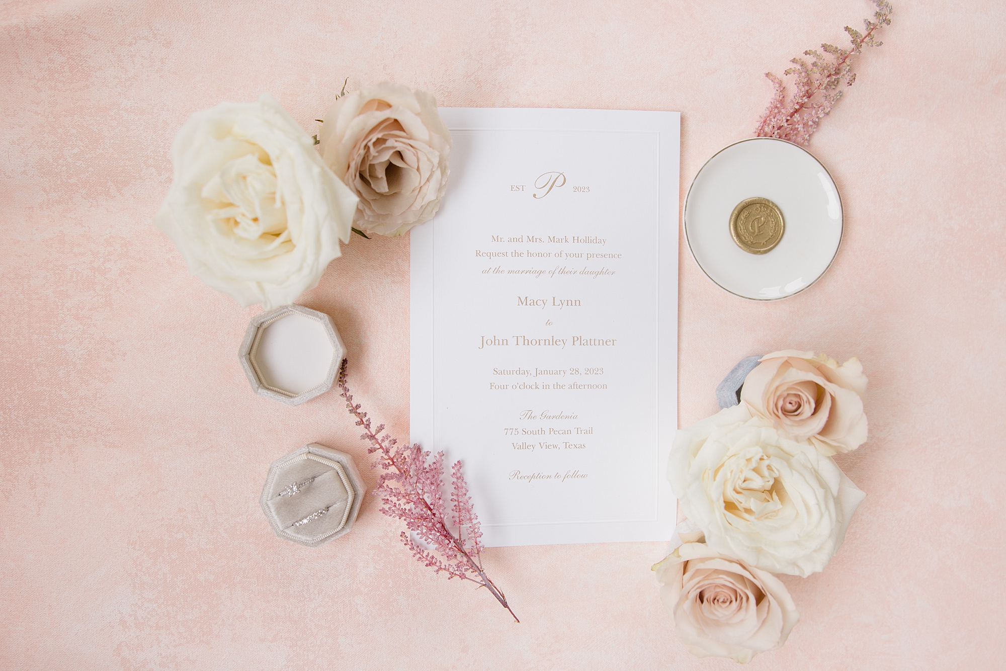 wedding invitation surrounded by pastel roses 