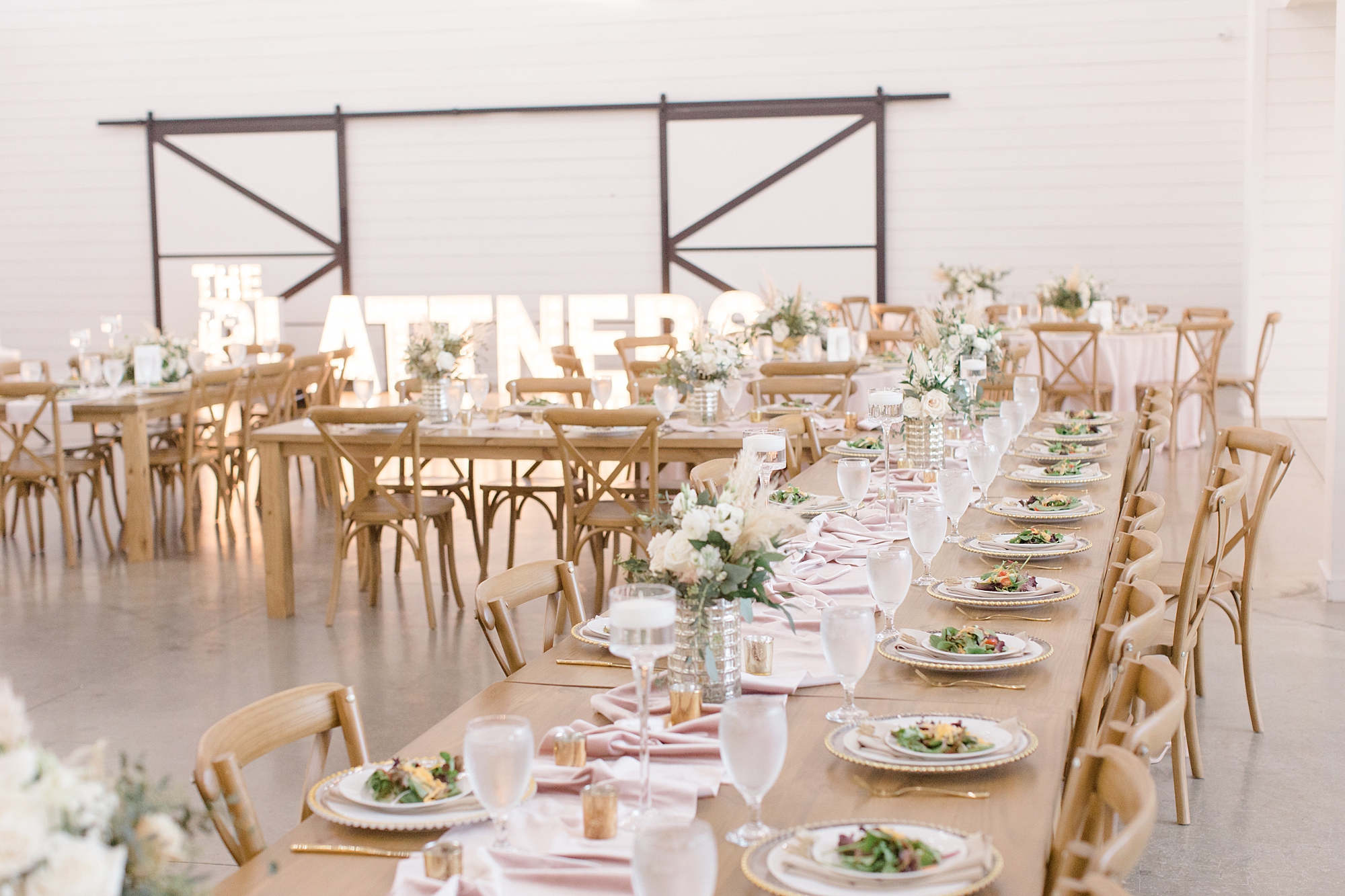 The Gardenia wedding reception with family style seating around wooden table 