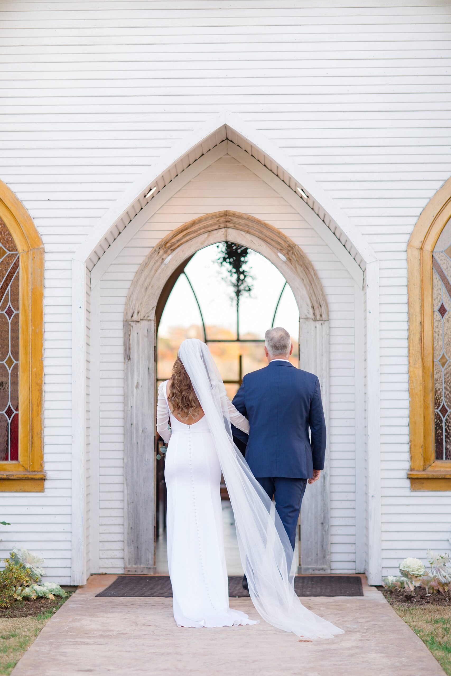 bride and father walk into chapel at The Brooks at Weatherford