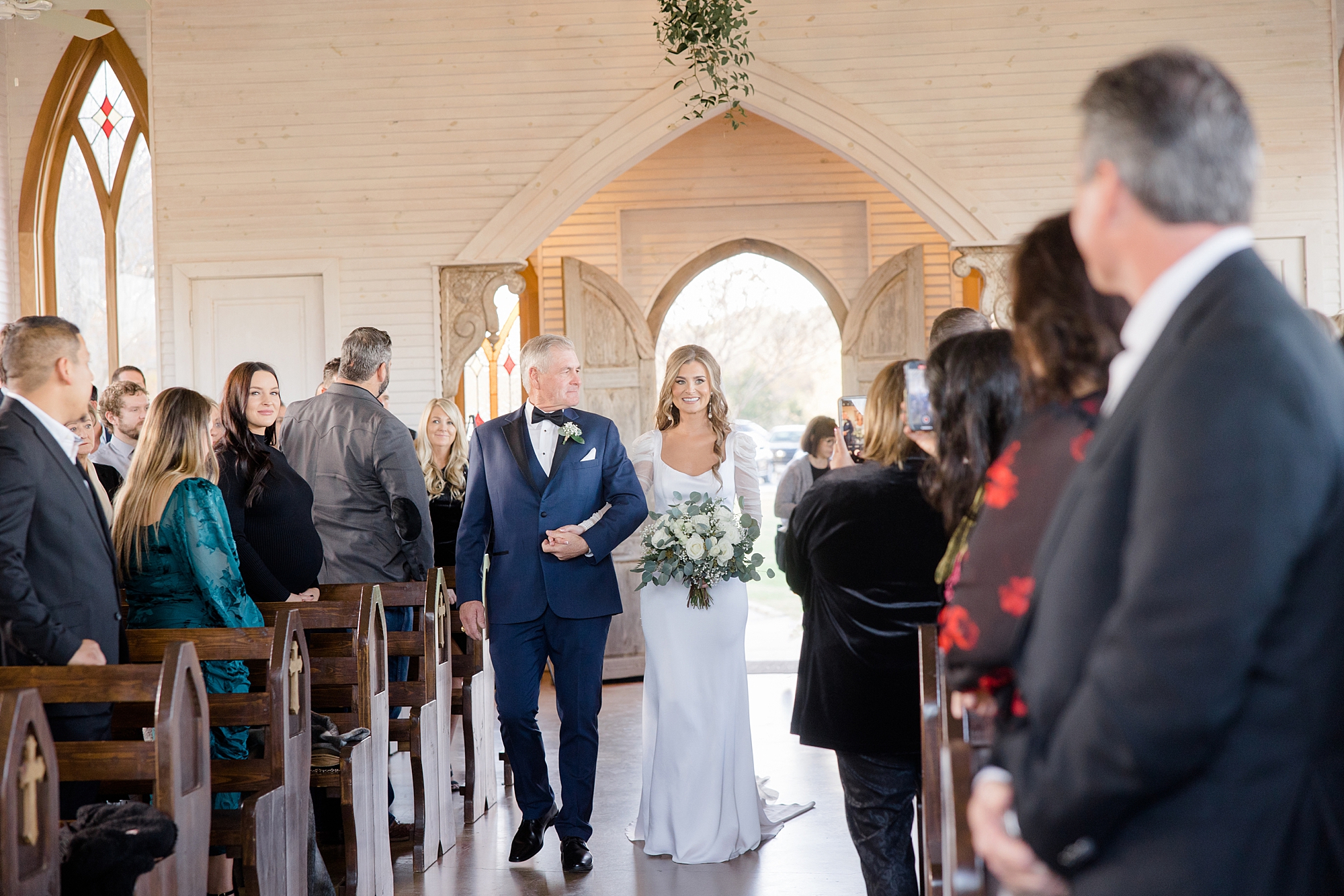 father walks bride down aisle in church at The Brooks at Weatherford