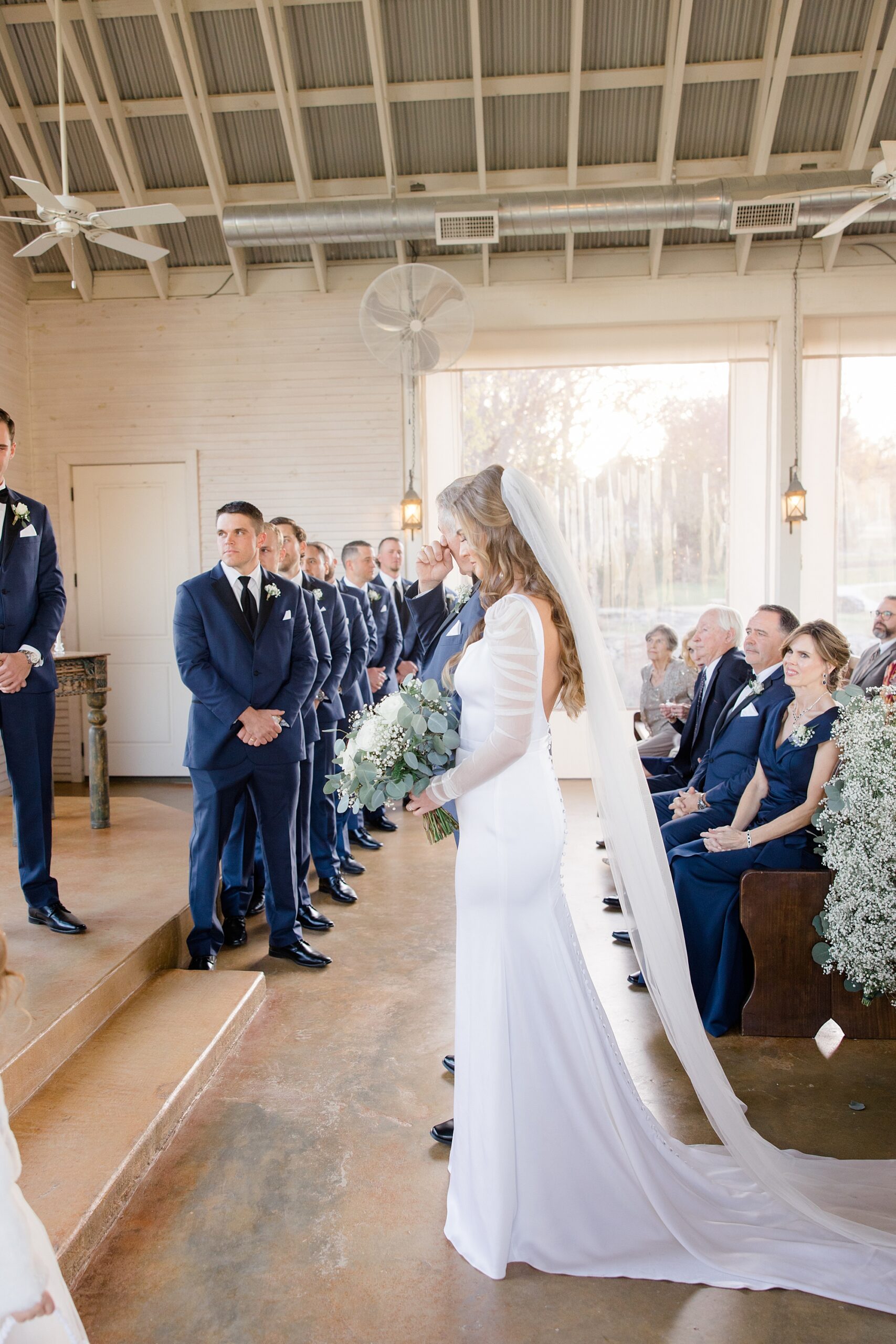 bride waits to approach altar with groom 