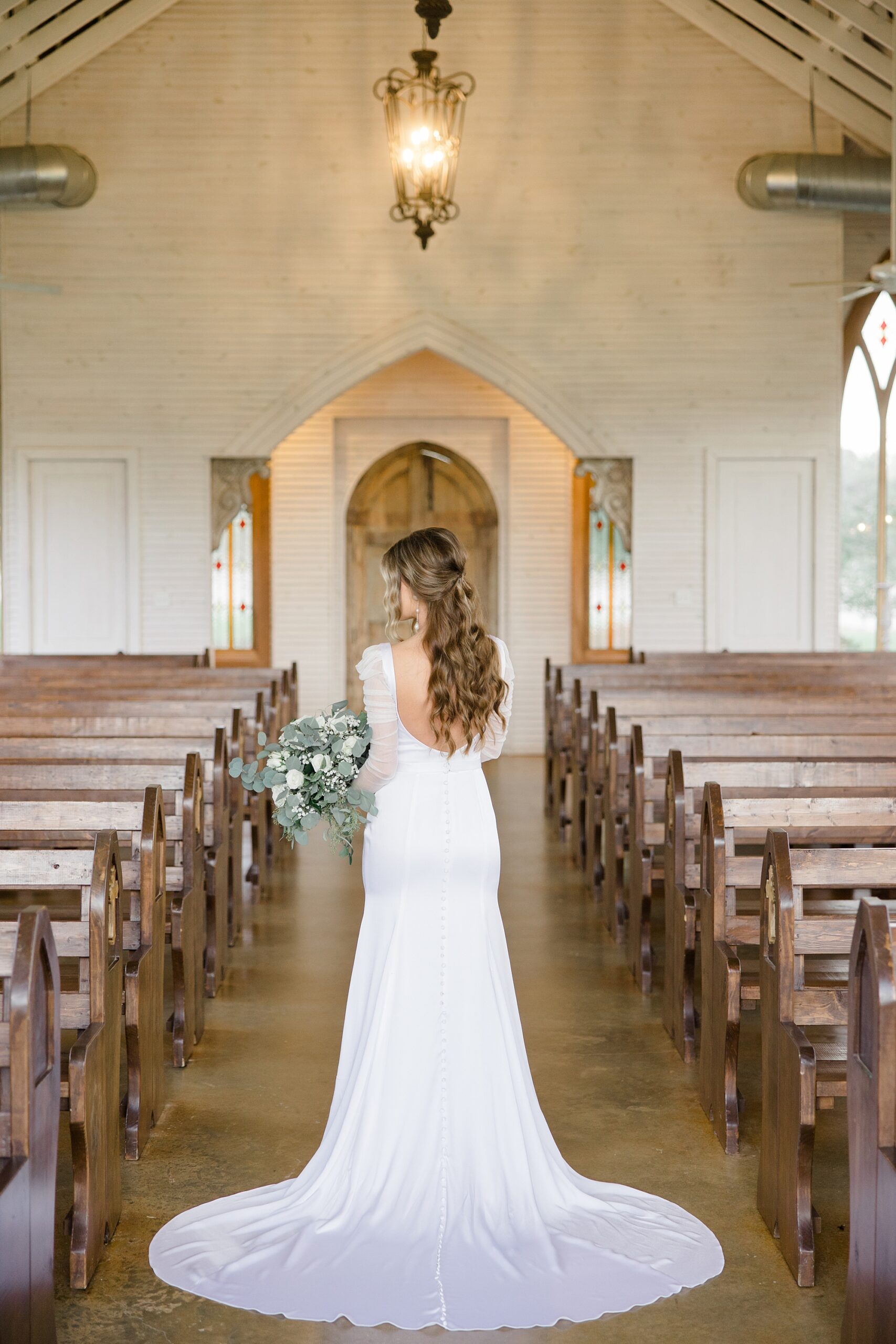 bride walks down aisle in chapel at The Brooks at Weatherford