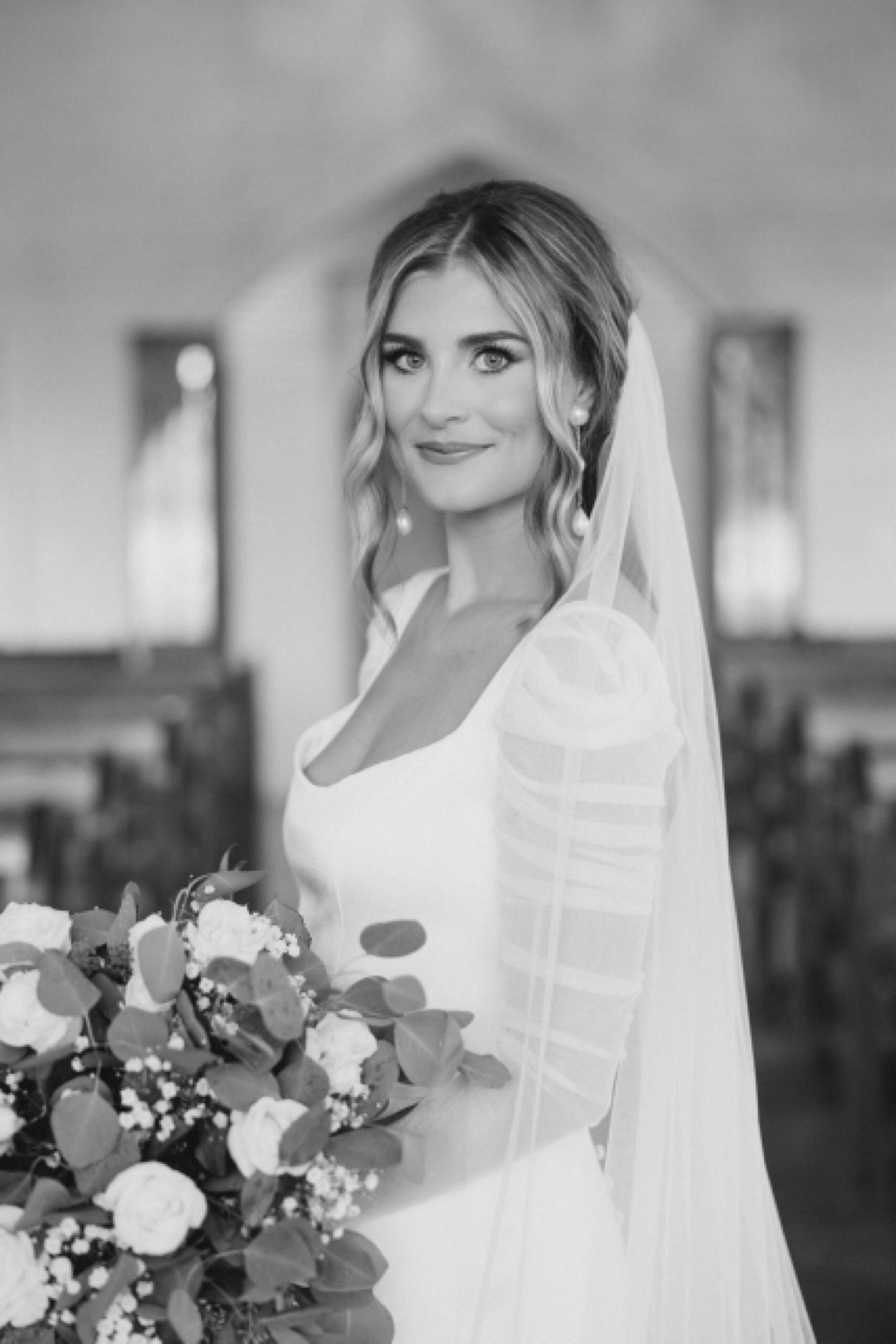 bride stands in between pews of chapel at The Brooks at Weatherford
