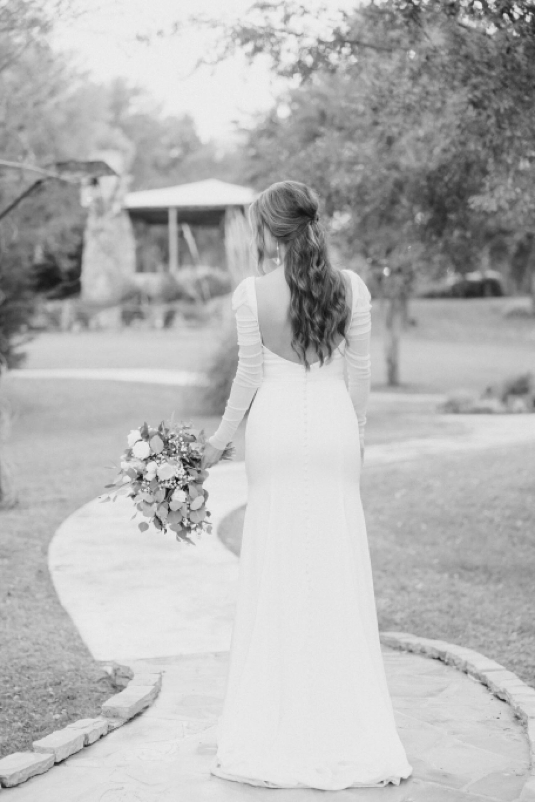 bride walks down pathway at The Brooks at Weatherford