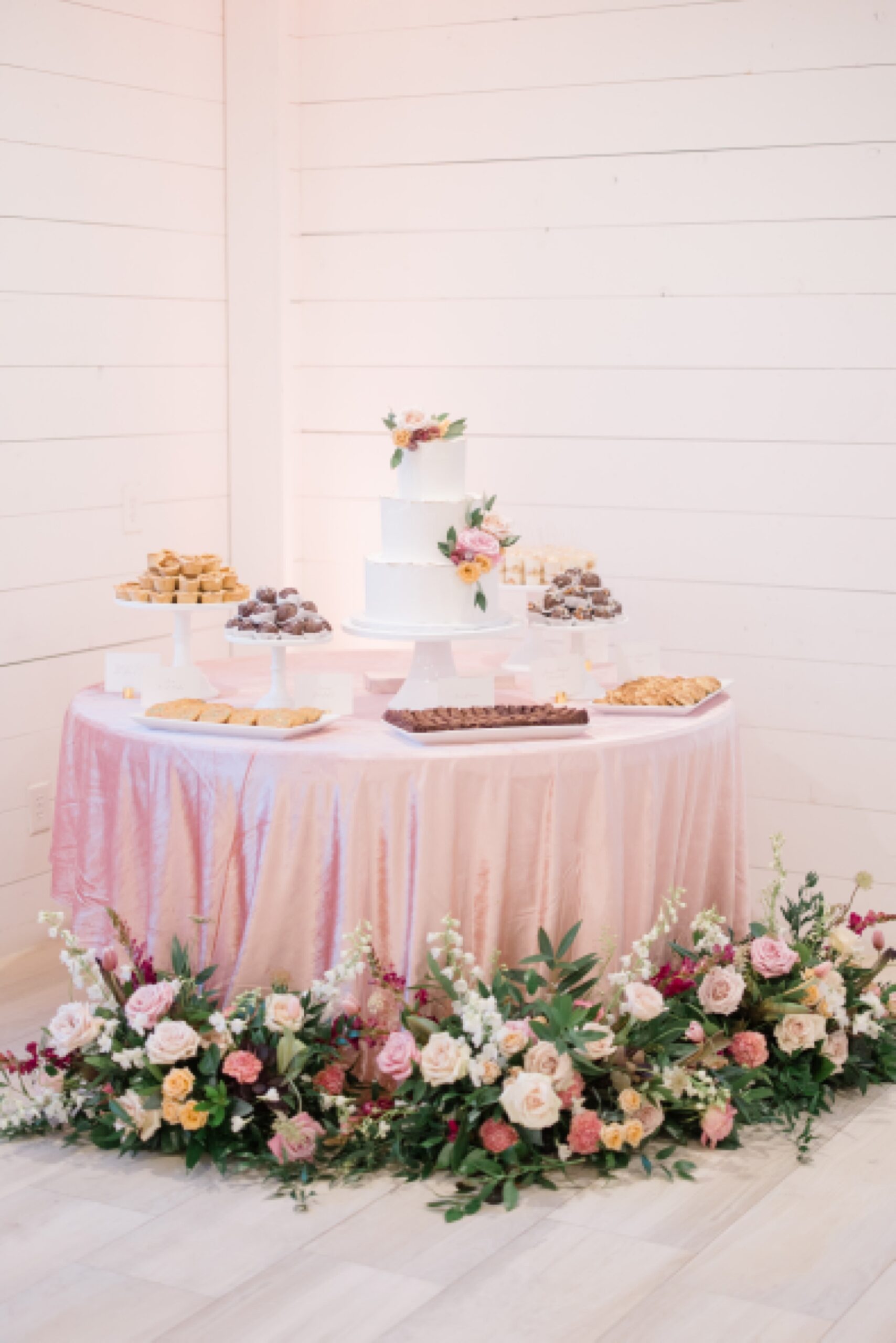 dessert display with cake and cookies at winter Nest at Ruth Farms wedding reception 