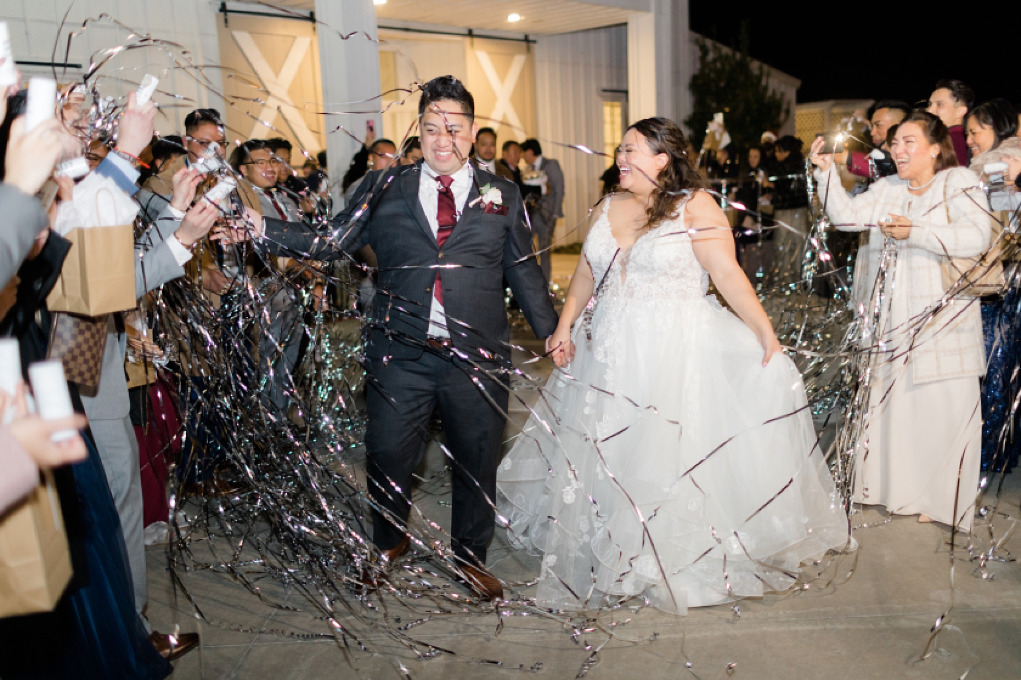 bride and groom leave in ribbon exit during Nest at Ruth Farms wedding reception