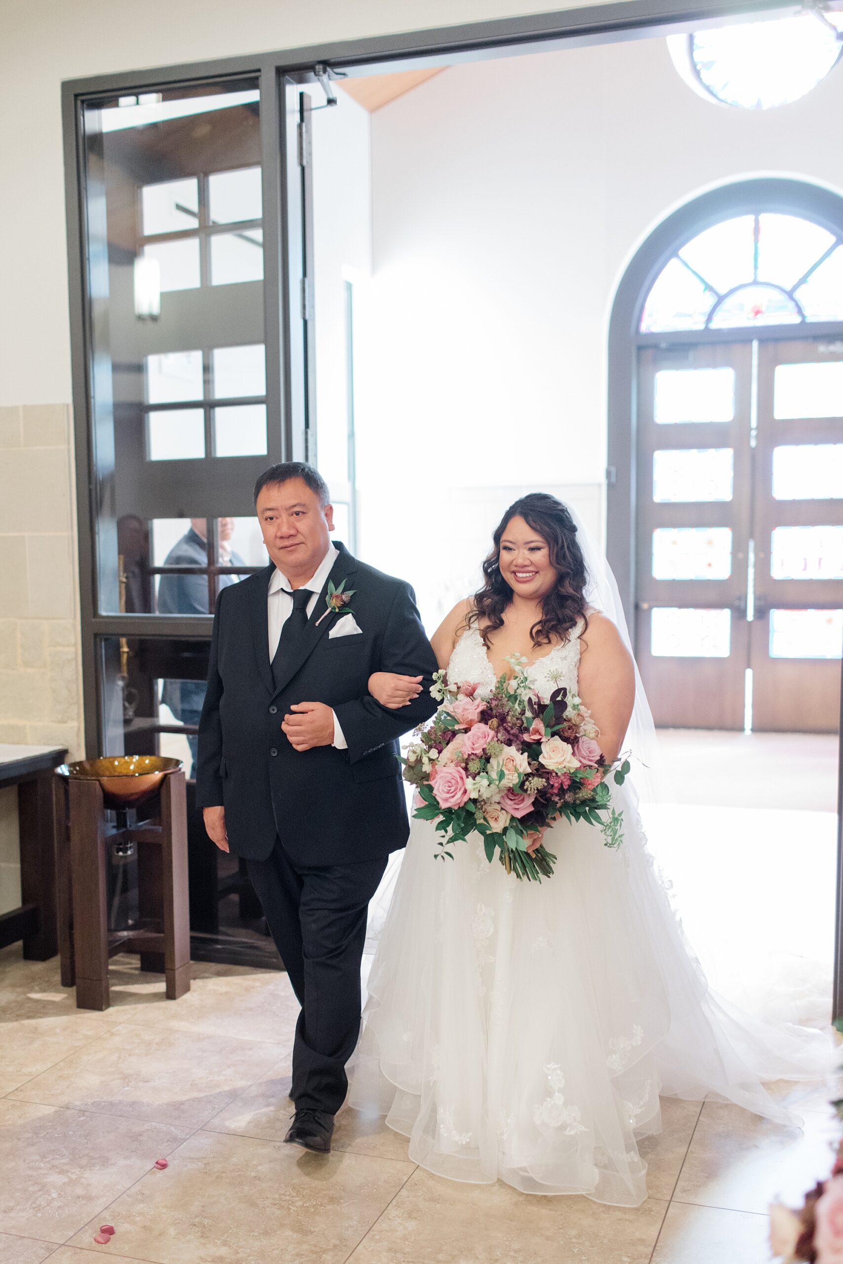 bride and father enter wedding ceremony at St. Francis of Assisi Catholic Church Frisco