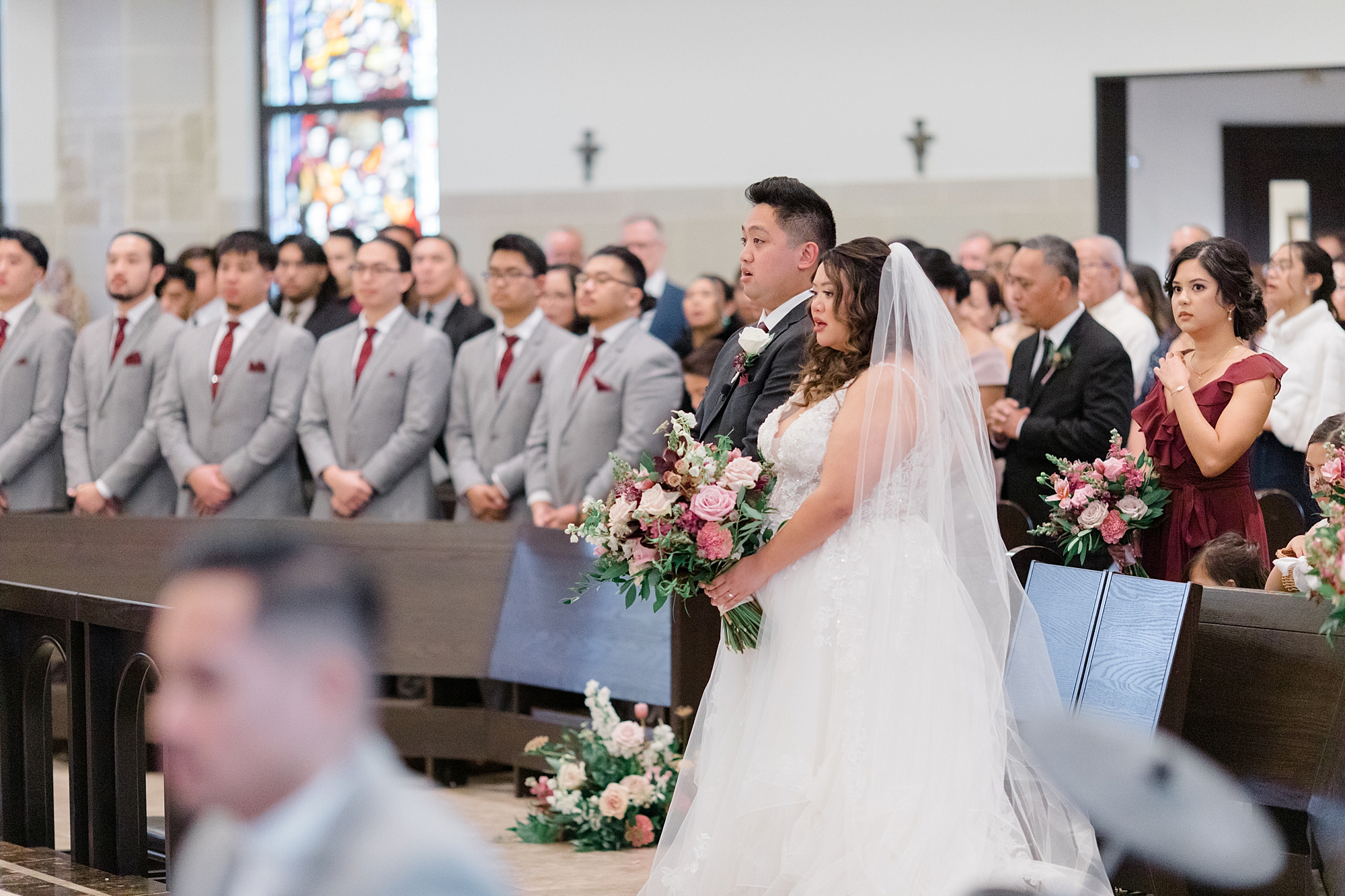 bride and groom listen to sermon during wedding at St. Francis of Assisi Catholic Church Frisco